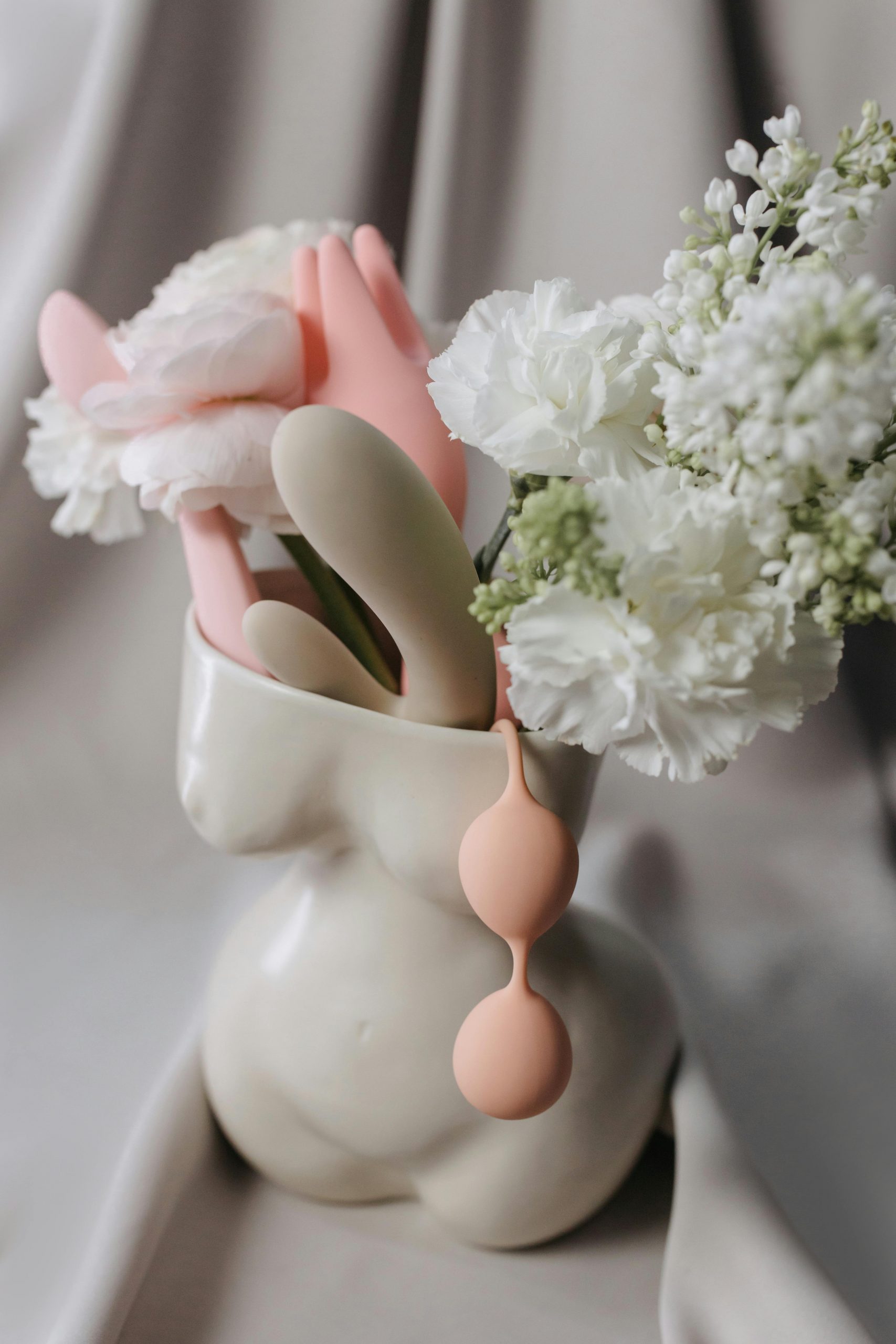 sex toys and flowers in woman body sculpture vase