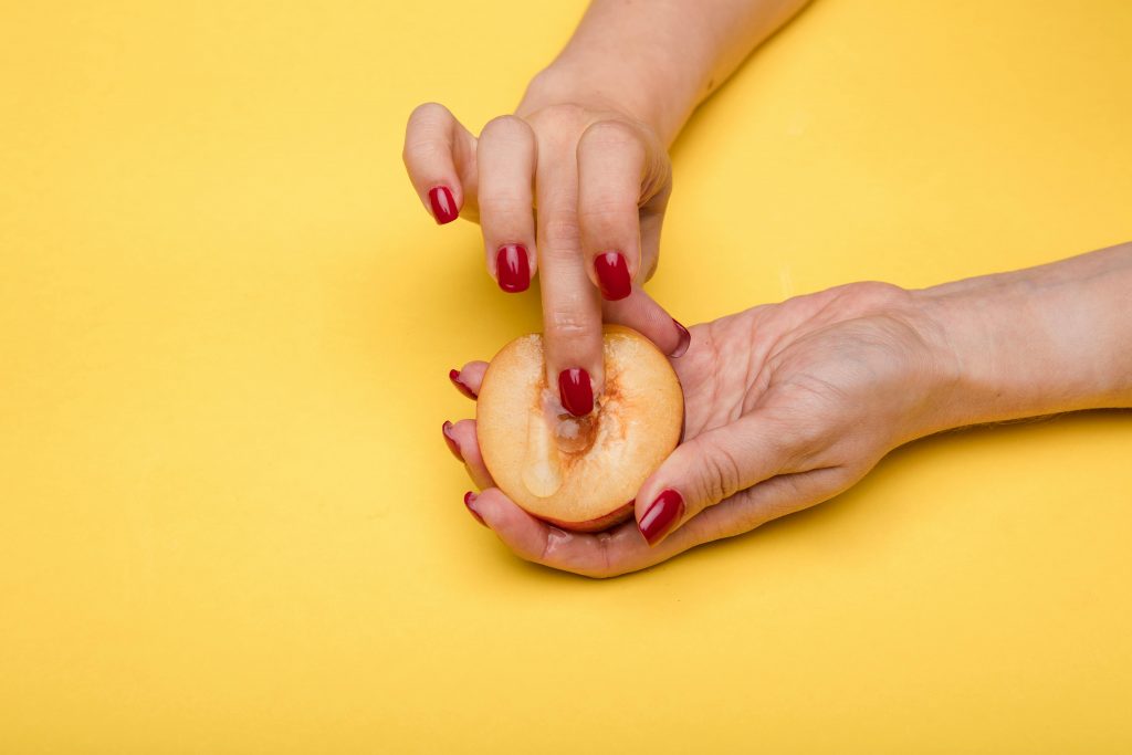 hands sensually touching fruit