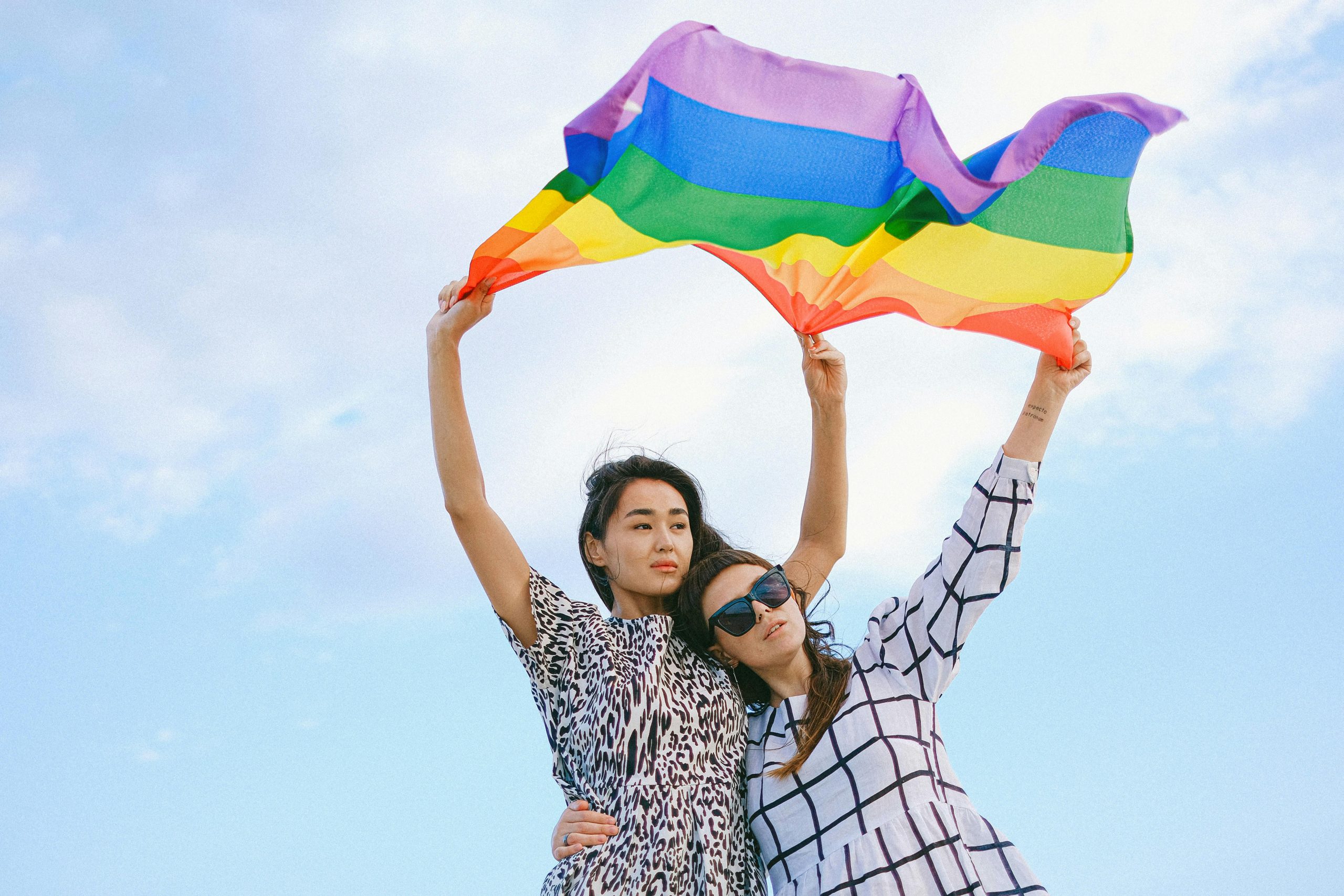 two people holding pride month flag