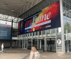 woman walking in front of erofame 2025
